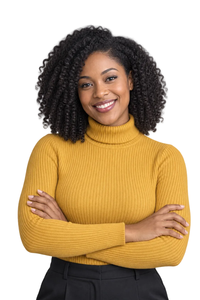 Woman with shoulder-length curly hair in a mustard turtleneck, arms crossed, smiling at the camera